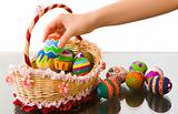 Arranging easter eggs in beautiful basket