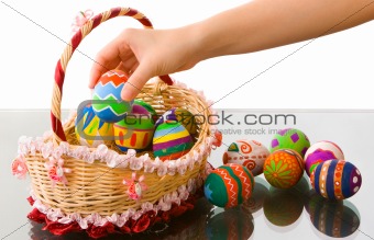 Arranging easter eggs in beautiful basket