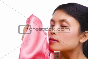 young woman smelling fresh laundry