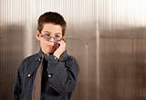 Little boy in adult clothes on cell phone