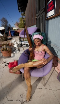 Black woman on back patio with rifle