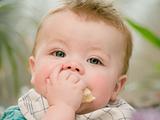 Portrait of a cute young baby boy eating