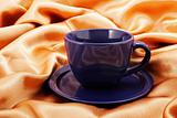 Cup and saucer on fabric