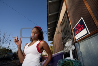 African-American woman in front of house