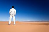 Man standing on a desert dune