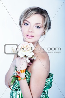 Closeup portrait of beautiful female smiling holding a flower