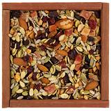 trail mix with nuts, berries and seeds in a wooden box