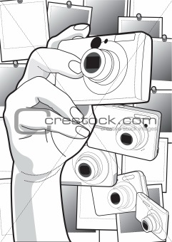 Close-up of a human hand photographing with a digital camera in