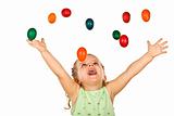 Happy shouting little girl with falling easter eggs