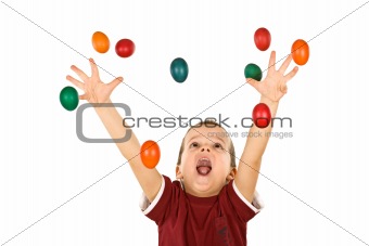 Happy boy reaching for the falling easter eggs