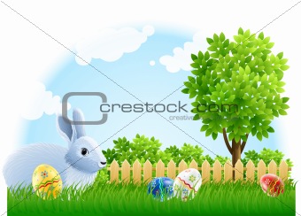 easter rabbit and eggs on the green garden grass