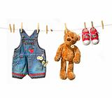 Child's clothes with teddy bear on clothesline