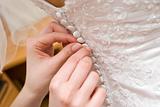 putting on a wedding dress with buttons