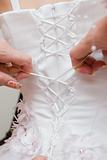 lacing up a wedding dress