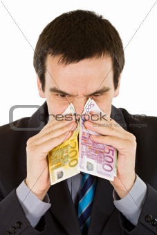 Businessman blowing his nose