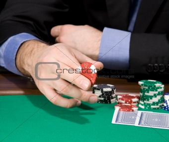 Hand with casino chip