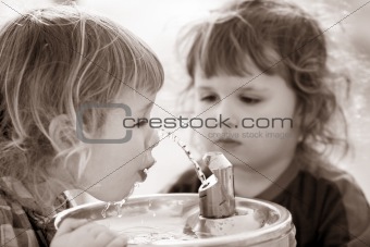 Two boys by the drinking fountain