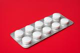blister pack containing tablets on a red background