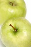 Two green apples on a white background