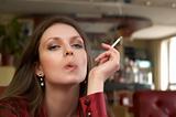 sesy green eyes brunete in red with smoking cigarette