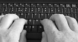 Close-up of businessman's hands on the keyboard.