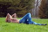 cheerful girl laying on the green grass.