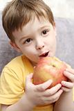 Emotions of the child which are held in hands with a red apple