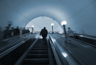 Commuters in Moscow metro on escalator steps