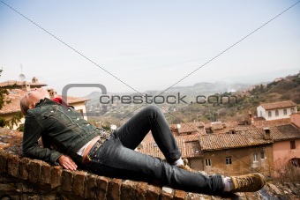 Woman Laying On The Wall Over The Old ItalianTown