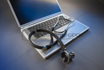 Laptop and stethoscope in blue