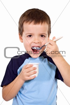 Little boy eating yogurt
