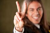 Handsome man in formalwear making a peace sign