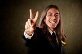 Handsome man in formalwear making a peace sign