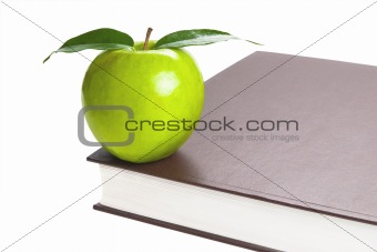Book and green apple