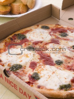 Cheese, Tomato And Pesto Pizza In A Take Away Box With Garlic Br