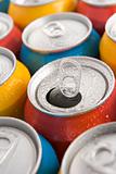 Close Up Of Multi Colored Soda Cans With One Open
