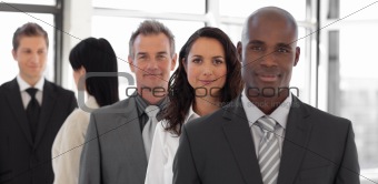 Serious business leader in front of business team 