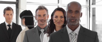 Serious business leader in front of business team 