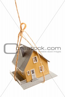 House Hanging by a String Isolated on a White Background.
