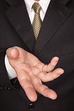 Businessman with Coat and Tie Gesturing with Hand.