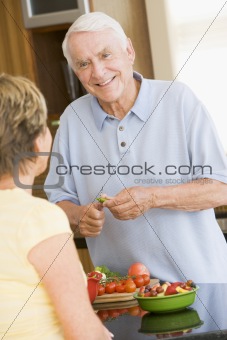 Husband And Wife Preparing Vegetables