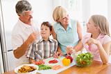 Grandparents And Grandchildren Prepare A meal,mealtime Together 