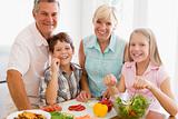 Grandparents And Grandchildren Prepare A meal,mealtime Together 