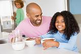 Father Sitting With Daughter As She They Eat Breakfast With Her 