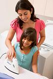 Mother And Daughter Ironing 