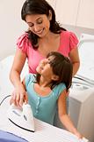Mother And Daughter Ironing 