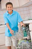 Young Boy Loading Dishwasher