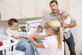 Father And Children Doing Laundry 