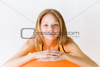 Happy fit woman with red fitness ball