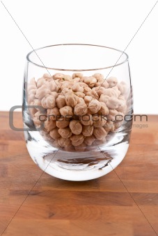 Chickpeas in Glass on wooden table